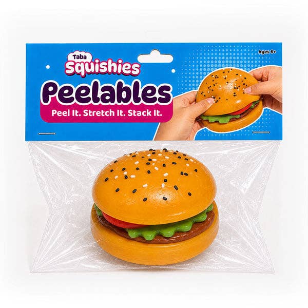 Taba Squishies Peelables toy burger packaged in clear plastic on a white background, with the blue retail header card showing the product name and a demonstration of hands peeling the toy.
