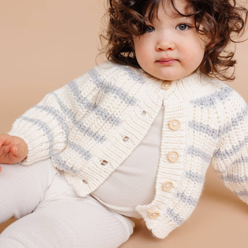 Toddler wearing The Blueberry Hill - Rib Knit Stripe Cardigan, Bowie Grey Baby Kid Sweater Basics, showcasing cozy neutral knitwear perfect for stylish kids clothing from a curated children’s boutique.