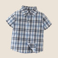 Fennco Styles - Blue Plaid Boy Cotton Button-Down Short-Sleeve Dress Shirt featuring a soft cotton fabric in a classic blue plaid pattern, perfect for stylish kids clothing from a curated children’s boutique.