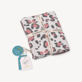 Folded Viverano Organics - Leopard - Organic Cotton Jacquard Sweater Knit Baby Blanket with pink and gray leopard print, tied with branded ribbon and attached product tags from a curated children’s boutique.