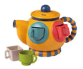 Colorful wooden teapot toy with matching green, beige, and blue cups, designed for playful learning with the Speedy Monkey - Teatime Shape Sorter in a stylish children’s boutique setting.