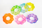 Five flower-shaped translucent slime rings in assorted colors, including orange, pink, purple, green, blue, and yellow, arranged on a plain white background.