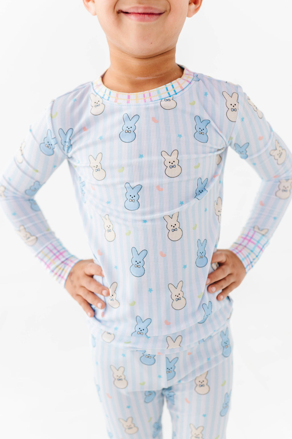 Child wearing Kiki + Lulu - Peeps + Sleeps Kids Pajamas with pastel bunny print on soft, breathable fabric, perfect for cozy nights and stylish kids clothing essentials.