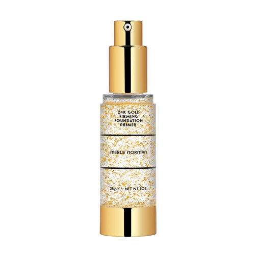 Merle Norman Cosmetics - 24K Gold Firming Foundation Primer in a clear pump bottle with gold flakes and shiny gold cap, designed for a luxurious skincare routine.