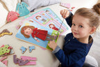 Young child playing with the Dress Me Threading & Lacing Game, an educational toy encouraging imaginative play and fine motor skills development in a cozy setting.