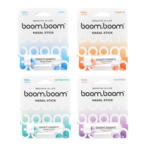 Four individually packaged BoomBoom - Nasal Stick tubes in mint, tropical, wintermint, and lavender scents, showcasing natural wellness products for modern families.