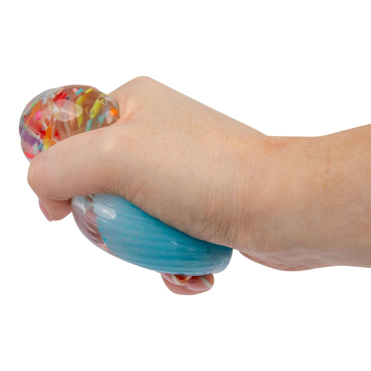 Hand squeezing a blue stress cupcake against a white background