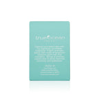 Back view of a turquoise box featuring a description of True Ocean - Coastal - a beach perfume, highlighting its light, aromatic blend with bergamot blossom, palm leaf, and mandarin notes.