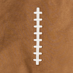 Close-up of a football sweatshirt with white laces on a brown background.