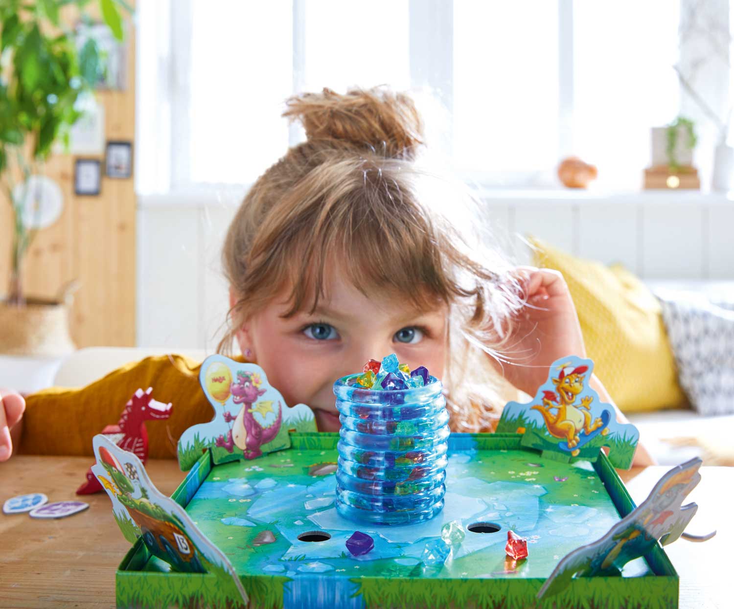 Young child playing the Dragon's Breath Game, a colorful and engaging educational toy encouraging imaginative play and sensory exploration in a cozy, well-lit room.