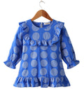 Fennco Styles - Blue Patterned Ruffle Girl Dress featuring large polka dots, long sleeves with ruffle cuffs, and ruffle accents on the neckline and hem, perfect for stylish kids clothing.