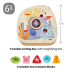Underwater World Wooden Shape Sorter featuring a wooden sorting box with magnifying lens and five colorful sea creature blocks, designed for imaginative play and sensory learning.