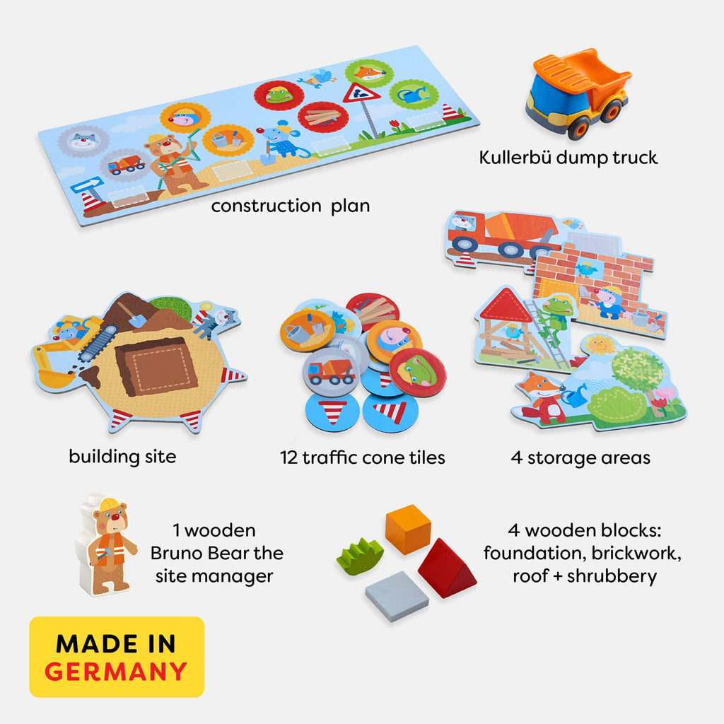 Layout of "My Very First Games - Building Site" featuring a wooden Bruno Bear site manager figure, Kullerbü dump truck, construction plan, building site, 12 traffic cone tiles, four storage area cards, and four wooden blocks representing foundation, brickwork, roof, and shrubbery.