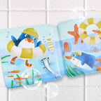 Open Penguin Bath Book with Squeaker featuring colorful illustrations of a penguin, sea creatures, and floating rings, designed for sensory and imaginative play during bath time.