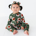 Baby wearing Kiki + Lulu - Rustic Blooms Ribbed Convertible Footies with Ruffle in green sunflower print, sitting on floor with matching headband, cozy and stylish children’s boutique outfit.