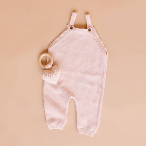 The Blueberry Hill - Overalls Blush Baby Gift Embroidery Blanks Spring Summer in soft blush pink knit fabric displayed with a wooden ring and heart-shaped plush toy, curated children’s boutique collection for stylish kids clothing and cozy baby essentials.
