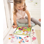 A young child playing with Peter and Pauline's Farm Magnetic Game, arranging colorful farm animal and character magnets on a board, encouraging imaginative play and learning.