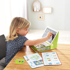 A young child playing with the 1, 2 Numbers & You Magnetic 158 Piece Game Box, using magnetic numbers and colorful educational boards on a wooden table in a bright, cozy room.