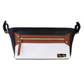 Itzy Ritzy - Coffee & Cream Travel Stroller + Wagon Caddy in black, brown, and cream with a front zipper pocket, designed for practical mom essentials and stylish kids accessories.