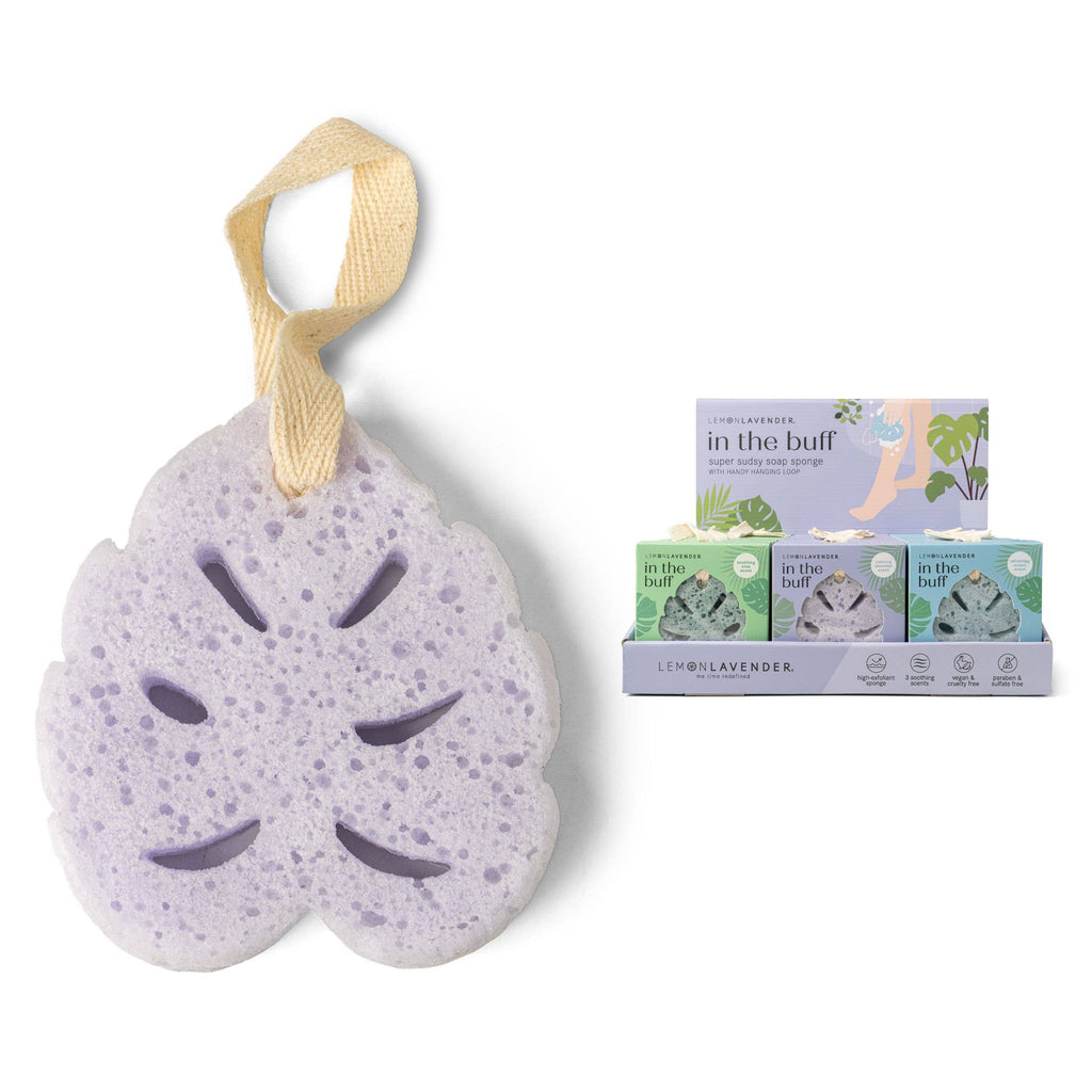 Lemon Lavender - In The Buff Super Sudsy Soap Sponge in a soft purple hue with a natural fiber hanging loop, displayed next to eco-friendly packaging from a curated children’s boutique specializing in mom life essentials.