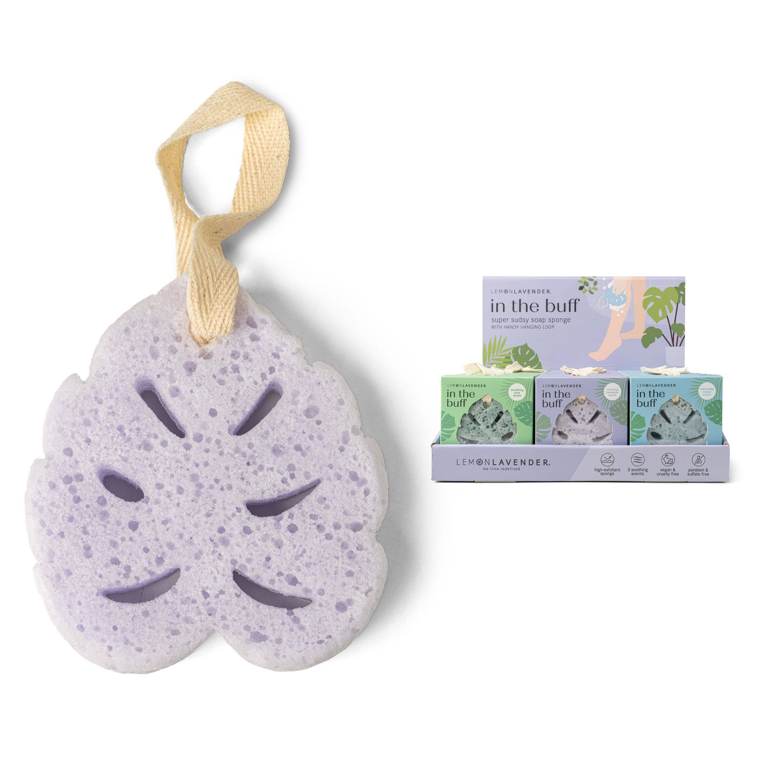 Lemon Lavender - In The Buff Super Sudsy Soap Sponge in a soft purple hue with a natural fiber hanging loop, displayed next to eco-friendly packaging from a curated children’s boutique specializing in mom life essentials.
