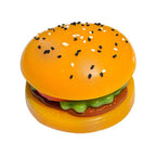 Toy hamburger with sesame seeds on a white background