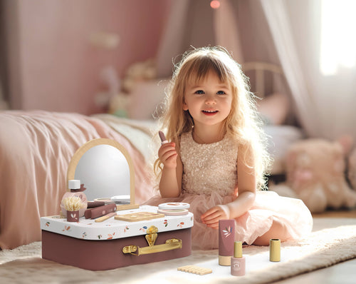 Little girl playing with Speedy Monkey - Beauty Suitcase, a stylish kids’ cosmetic play set, in a cozy, softly lit room reflecting curated children’s boutique charm.