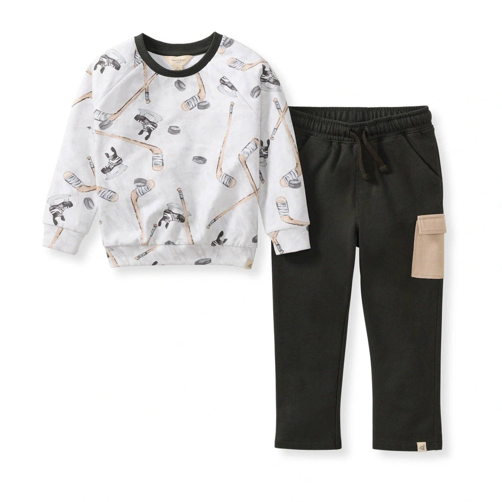 Burt's Bees Baby - Hockey Season Sweatshirt & Pants Set featuring a white sweatshirt with hockey stick and puck print paired with black pants with a beige pocket, cozy and stylish for babies.