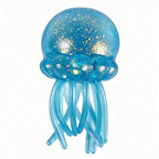 Blue jellyfish-shaped toy with glowing interior on a white background