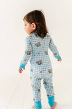 Child wearing a blue checkered onesie with 'Little Bro' text on a white background