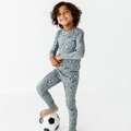 Child wearing Kiki + Lulu - Goal Hard or Go Home Toddler/Big Kid Pajamas in soft breathable fabric with playful soccer-themed prints, perfect for stylish kids clothing and cozy essentials.