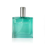 Clear turquoise glass perfume bottle with silver cap labeled True Ocean - Coastal - a beach perfume, showcasing a fresh and ocean-inspired scent for modern moms.