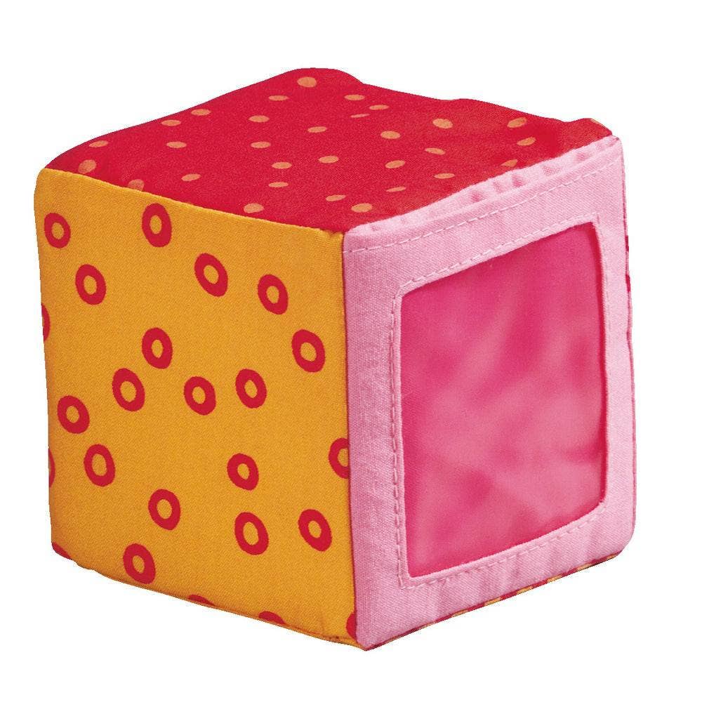 Soft fabric baby block with colorful red, orange, and pink patterns, part of the Happy Quartett Baby's 4 Piece Soft Block Set, designed for sensory play and safe baby interaction.