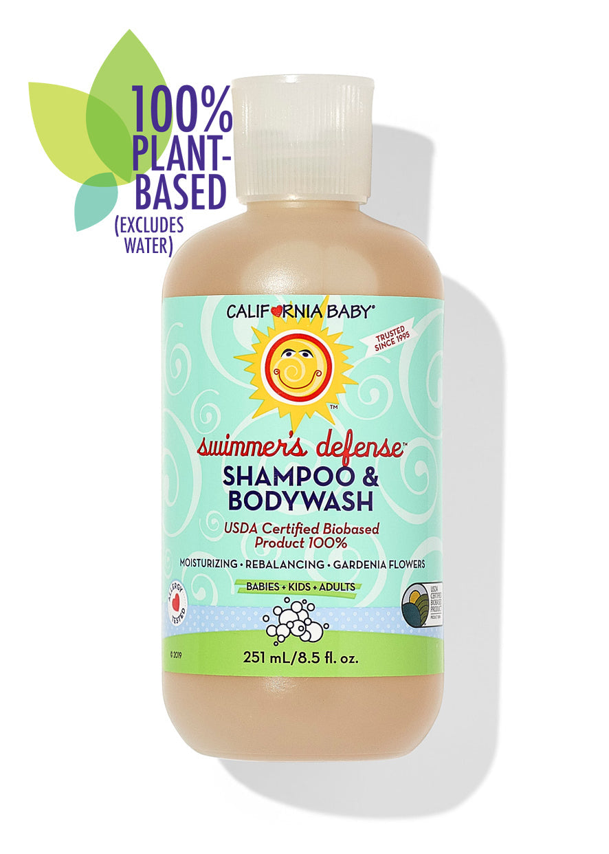 Bottle of California Baby - Swimmer's Defense™ Shampoo & Bodywash with a light blue label featuring a sun logo, highlighting 100% plant-based, moisturizing, and rebalancing benefits for babies, kids, and adults.