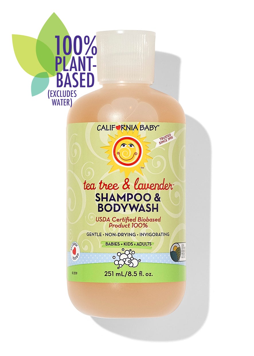 California Baby - Tea Tree & Lavender™ Shampoo & Bodywash bottle with a green label featuring a smiling sun logo, promoting 100% plant-based, gentle, non-drying, and invigorating formula for babies, kids, and adults.