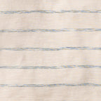 Textured fabric with horizontal blue stripes on a beige background