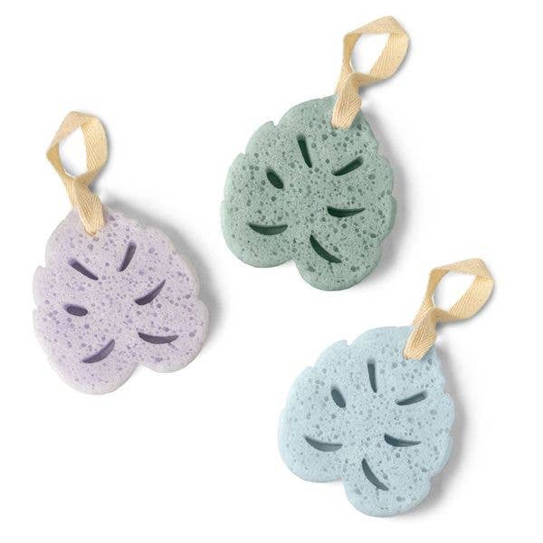 Three leaf-shaped bath sponges in pastel green, lavender, and blue with hanging loops, featured in the Lemon Lavender - In The Buff Super Sudsy Soap Sponge collection for cozy baby essentials.