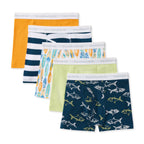 A 5-pack of children's boxer briefs, displayed in a staggered fan layout. The set includes solid orange, navy and white stripes, a surfboard pattern, and a light green pair, with the front pair featuring a navy blue shark print.