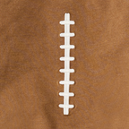 Close-up of a football sweatshirt with white laces on a brown background.