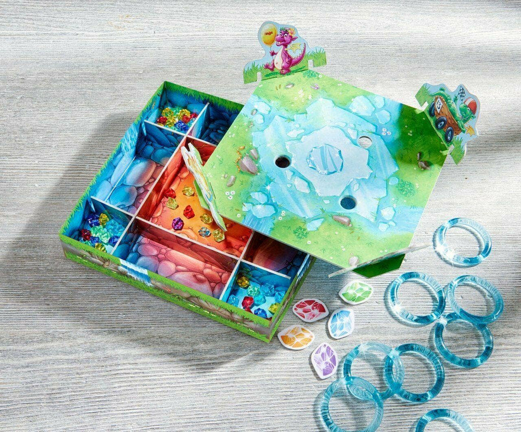 Dragon's Breath Game with colorful gems, blue circular rings, and a vibrant game board featuring an icy landscape and playful dragon illustrations for imaginative play.