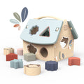 Wooden toy house with pastel-colored removable shapes for sorting, encouraging playful learning and imaginative play, part of Speedy Monkey - House Shape Sorter.