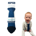 Tasty Tie® - Tasty Tie Teether, Crinkle Toy, Baby Boy Gift: Polkadot shown with smiling baby wearing navy blue polkadot teething tie made from organic cotton, ideal as a stylish baby shower gift.