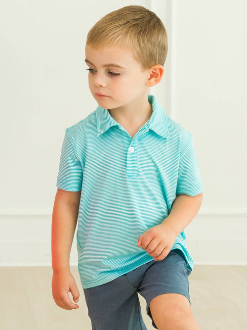 Young boy wearing RuffleButts + RuggedButts - Boys Bright Aqua Micro Stripe Knit Short Sleeve Performance Polo: Blue, styled in a cozy, breathable outfit from a curated children’s boutique.