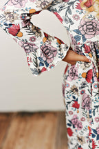 Floral dress with bell sleeves on a plain background