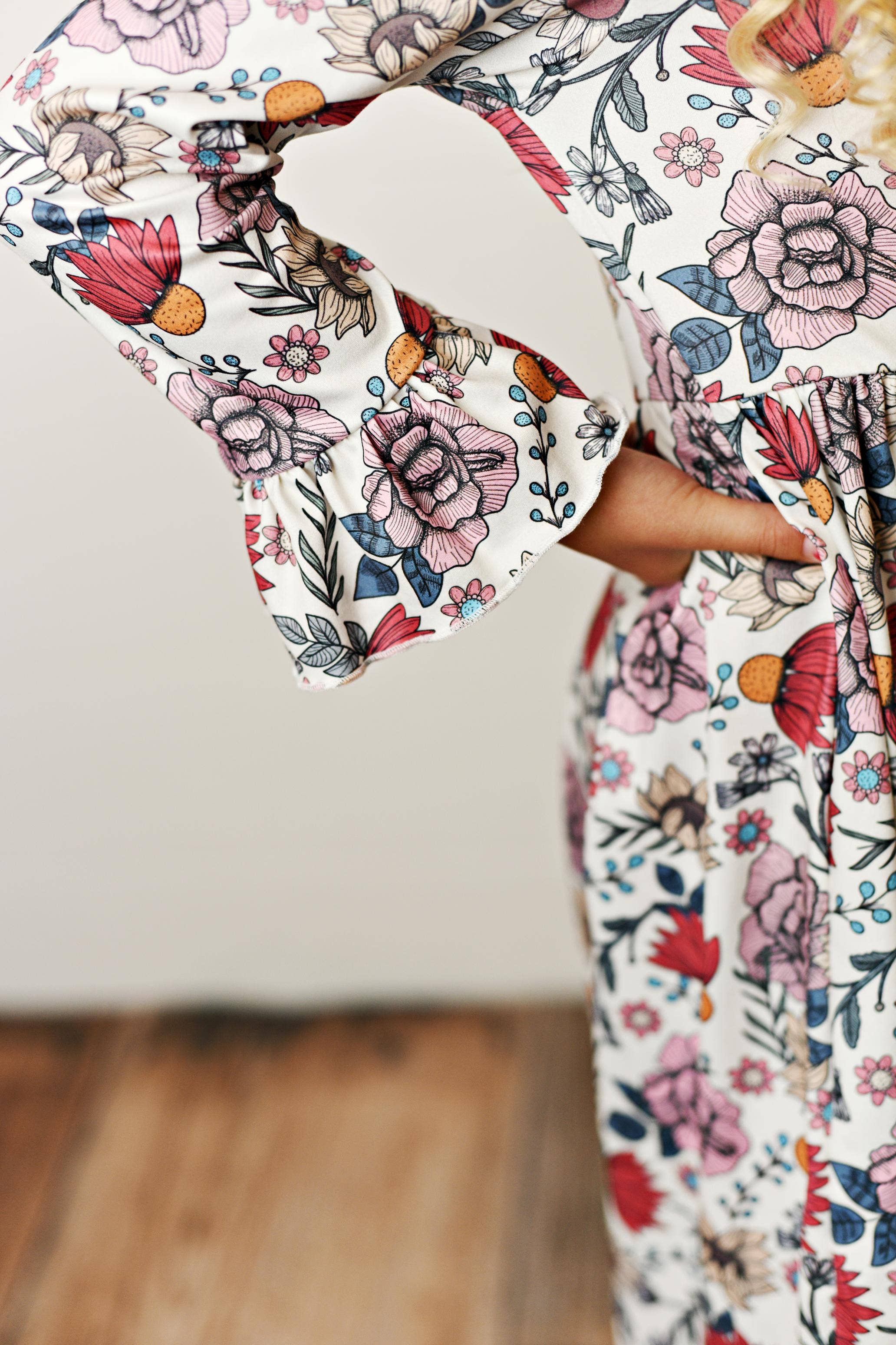 Floral dress with bell sleeves on a plain background