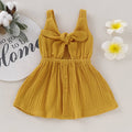 Fennco Styles - Front Tie Bowknot Gauze Cotton Girl Dress: Mustard displayed flat on a neutral background with decorative flowers and a cotton branch, showcasing breathable soft fabric in a charming mustard color.