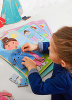 Child playing with the Dress Me Threading & Lacing Game, threading a string through dress pieces on a wooden figure, encouraging fine motor skills and imaginative play.