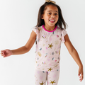 Happy toddler girl wearing Kiki + Lulu - That's What Sea Said Ruffle Pajamas Toddler/Kids with sea-themed print in soft pastel colors, perfect for cozy kids sleepwear.