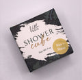 Villa Bain - Rise + Shine Shower Cube in stylish packaging with black, white, and gold accents, featuring a nature-inspired design for a modern, cozy bath experience.