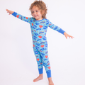 Child wearing vibrant blue Kiki + Lulu - Kiki + Lulu x Rydel SUPER Toddler/Big Kid Pajamas with playful cartoon and comic book-style graphics in a bright, cozy design.